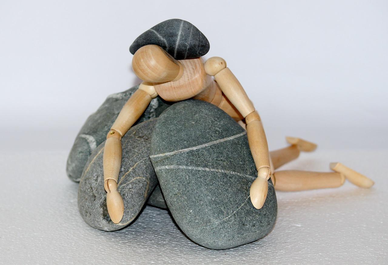 wooden figure, stones, struggle for life-980784.jpg